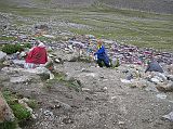 Tibet Kailash 09 Kora 03 Shiva Tsal It took us 85 minutes to trek from Dirapuk to Shiva Tsal (5330m), said to be a replica of the fabled burial ground at Bodh Gaya India. To be reborn one must first die, and here the pilgrims face Yama, the Lord of Death, whose judgment purifies him for the new life awarded atop the Dlma La. It is a rocky expanse dotted with stone cairns draped with items of clothing. Pilgrims are supposed to undergo a symbolic death at this point, leaving their old life behind along with an item of clothing to represent it, a drop of blood or a lock of hair. I left a pair of socks while Pete left a hat.